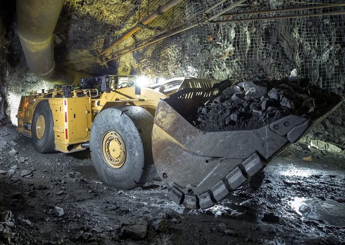 Underground loader hauling ore in a mine tunnel